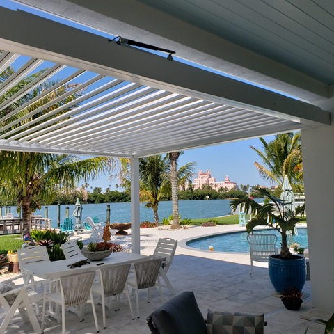 motorized retractable pergola open over backyard patio