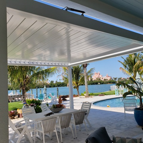 motorized retractable pergola closed over backyard patio